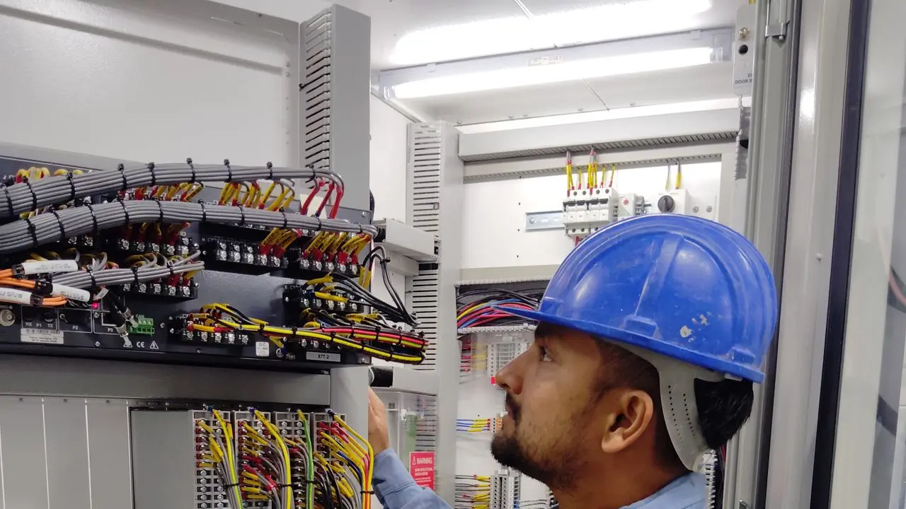Técnico trabajando con cables en una instalación eléctrica